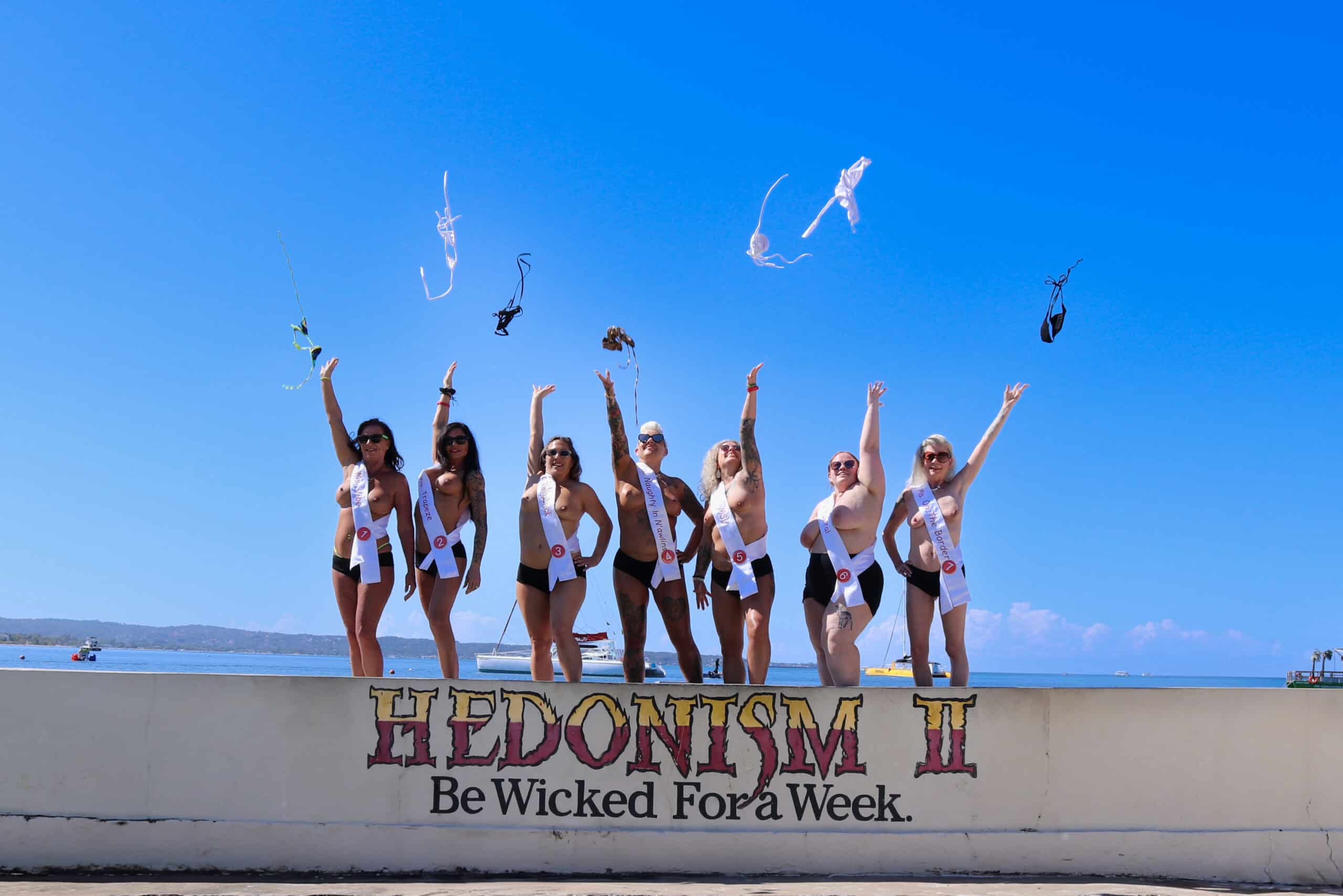 Ms No Swimsuit 2025 contestants celebrating on the Hedonism II wall in Jamaica